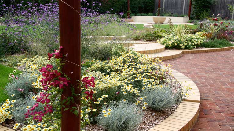 Gentle brick terraces and ebullient borders