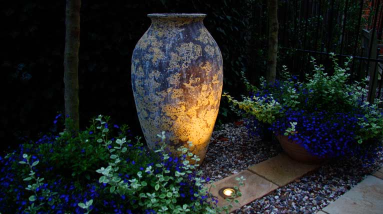 Rustic urn spotlit for drama