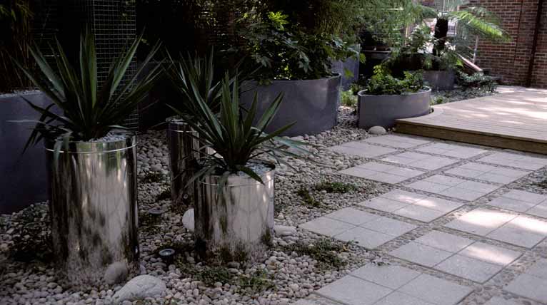 Curved garden reflections in stainless steel planters