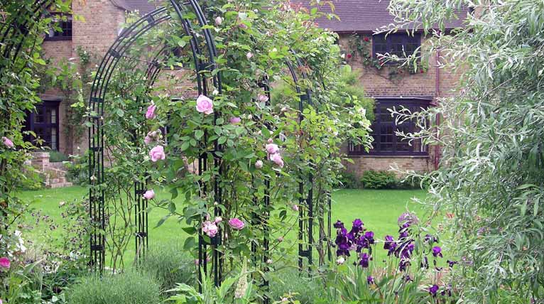 Bespoke steel rose arches for a Arts and Crafts property